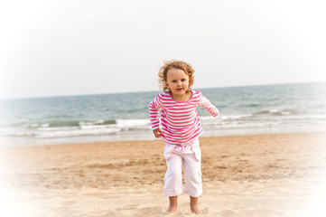 Little girl is running on the beach