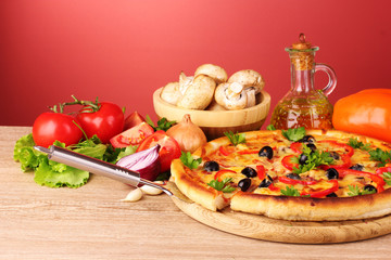 pizza and vegetables on a red background