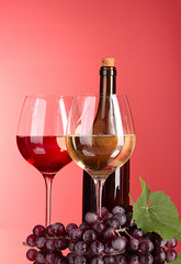 Wine bottle and glass on red background