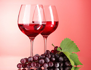 Wine bottle and glass on red background