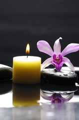 Obraz na płótnie Canvas aromatherapy candle and pink orchid on zen stones
