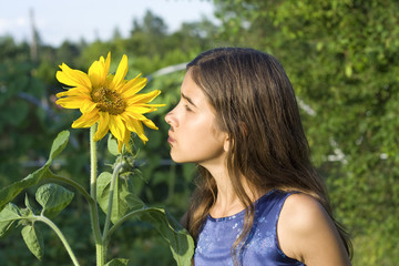 Girl smelling sunflower