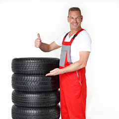 Master mechanic is proud of his winter tires and shows thump up