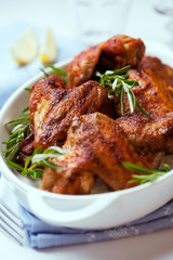 Roasted chicken wings with rosemary sprigs