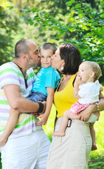Fototapeta premium happy young couple with their children have fun at park