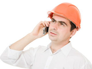 Businessman in helmet on the phone.