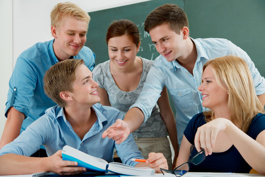 group of students studying together in a classroom