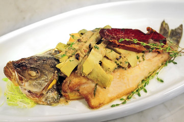 Trout, baked with vegetable on white plate