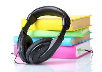 Headphones on books isolated on white