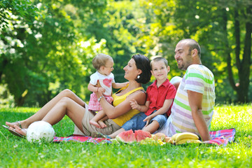 Fototapeta premium happy young couple with their children have fun at park