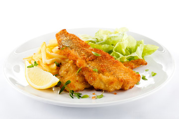 Fish dish - fried fish fillet, French fries with vegetables