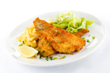 Fish dish - fried fish fillet, French fries with vegetables