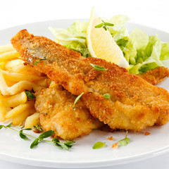 Fish dish - fried fish fillet, French fries with vegetables