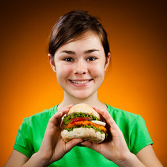 Girl eating big hamburger