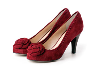Pair of red suede female shoes over white