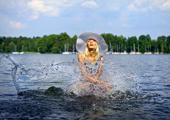 Beautiful blond model standing on water.