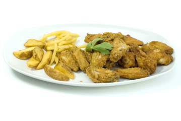 golden fried chicken and fried potatoes in a white plate