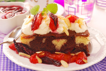 homemade cake with plums and whipped cream