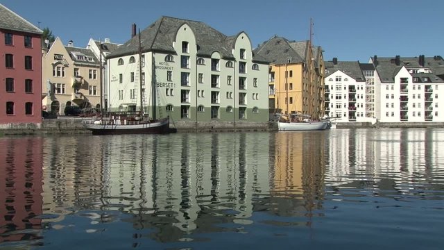 Static clip of colourful buildings with reflection in the water in Alesund, Norway