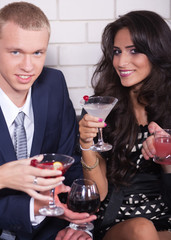 Couple on date in bar or night club enjoying wine