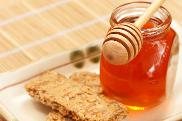 Honey with cereal butter and wood dipper