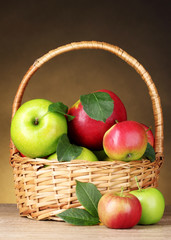 Basket of organic apples on brown background