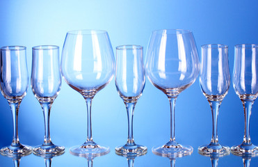 Few empty wine glasses on blue background