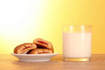 cookies with milk on yellow background
