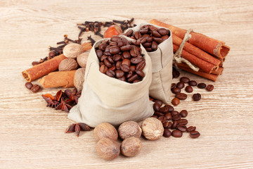 cinnamon, coffee, nutmeg and hazelnut on wooden background