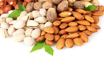 almonds, nutmeg, peanuts and pistachios isolated on white