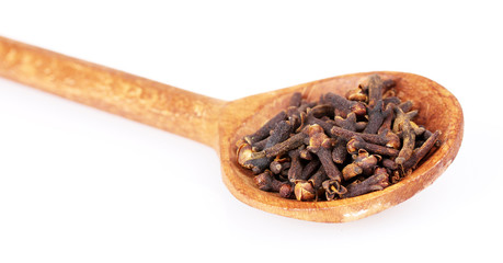 spices in the spoons isolated on white