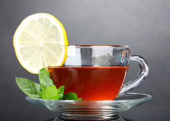 tea with lemon and mint on gray background