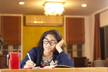 sleepy student, a girl act sleep during her book study.