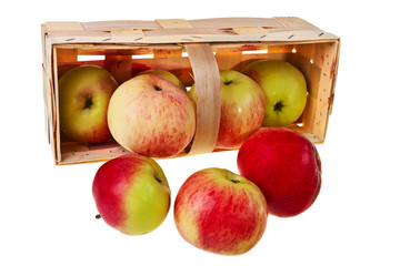 Fresh green, red apples in wooden basket over white background.