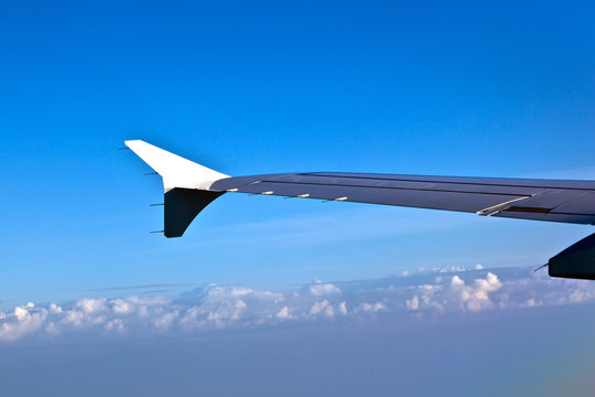 wing of aircraft in blue sky