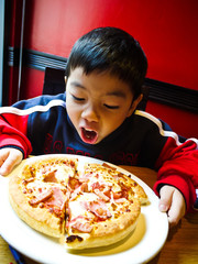 Asian Boy ready to eat a pizza