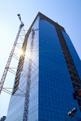 Fototapeta premium Building crane and building under construction
