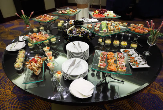 Table With Cold Snacks And Tableware On Luxury Stand-up Party