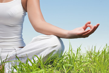 woman hands in yoga meditation pose outdoors