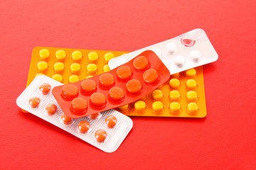 medicine pills pack pile closeup on red  background