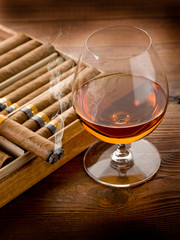 cuban cigar and cognac on wood background