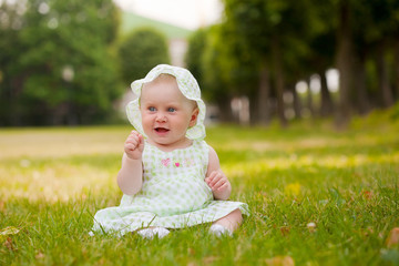 Summer portrait of beautiful baby on the lawn
