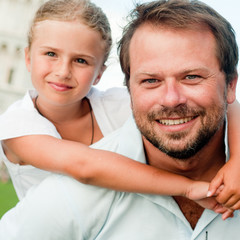 Happy childhood - father and daughter outdoor portrait