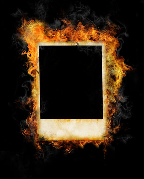 Old blank photo frame in fire