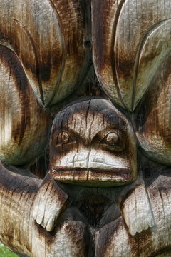 Dolphin carving on totem pole
