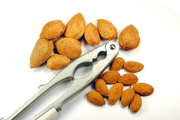 whole and cracked almonds with nutcracker