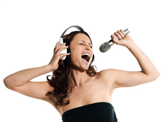Portrait of a beautiful woman with microphone and headphones sin