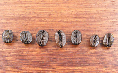 The coffee beans lined up on a wooden floor.