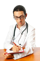 Doctor sitting at the desk on white