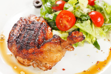 Roasted chicken leg with salad